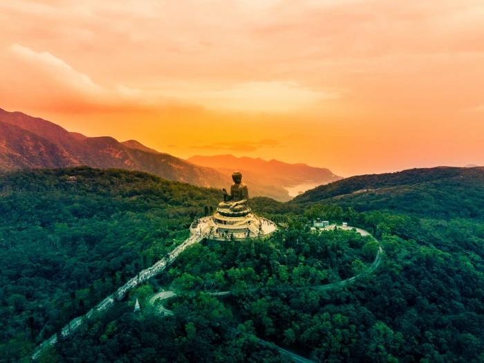 sitting budha statue on temple at the center of forest worship 2k 4k