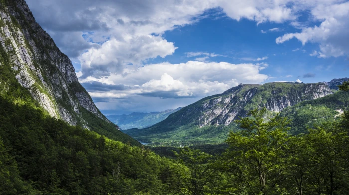 green mountains under white and blue cloudy sky during daytime 2k 4k 5k
