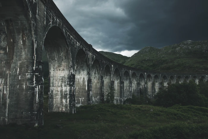 grey concrete bridge near hills landscape photography of mountain 2k 4k 5k