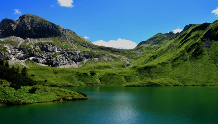 landscape photography of green mountains near body water during day time 2k 4k 5k