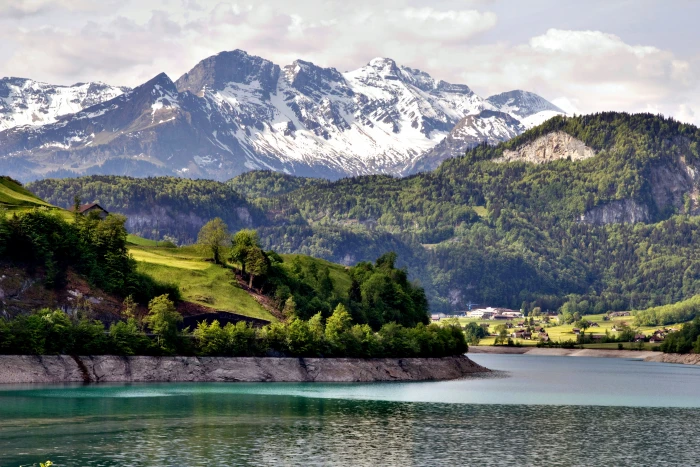 landscape photography of mountains surrounded by body water 2k 4k 5k