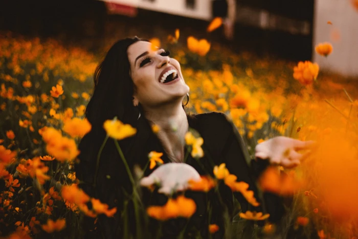 Laughing woman in flowers with smile people happy nature women 2k 4k 5k