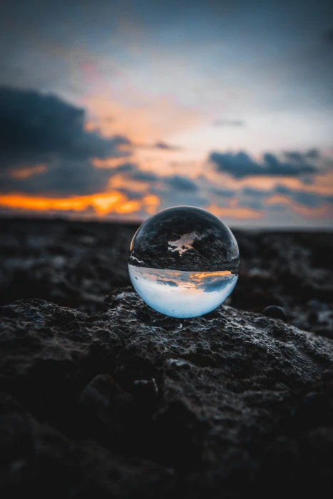 marble toy mirror ball on stone during golden hour glass globe 2k 4k