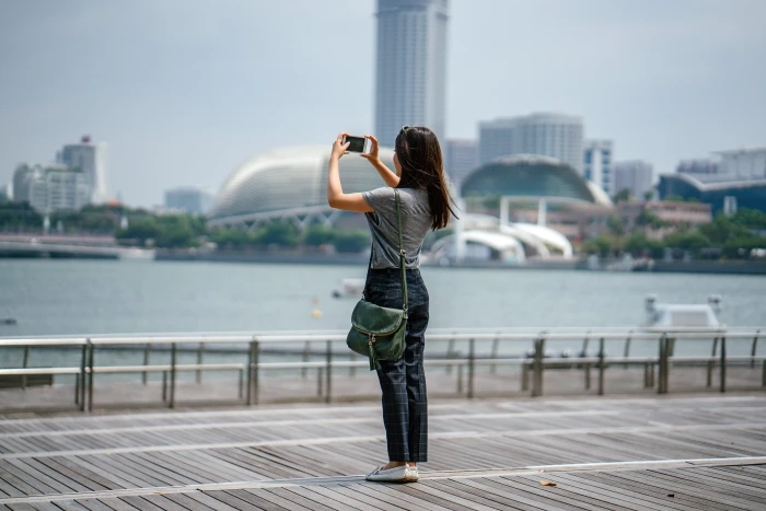 Woman Standing Taking Picture of Scenery architecture bay blurred background 2k 4k 5k 8k