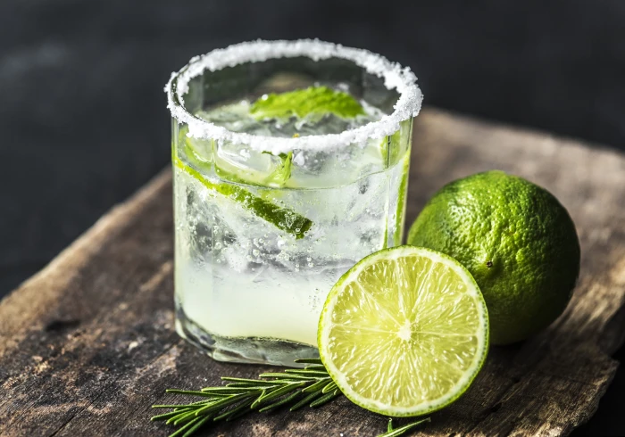 Sliced Lime Fruit Near Clear Drinking Glass With Juice on Brown Wooden Plank 2k 4k