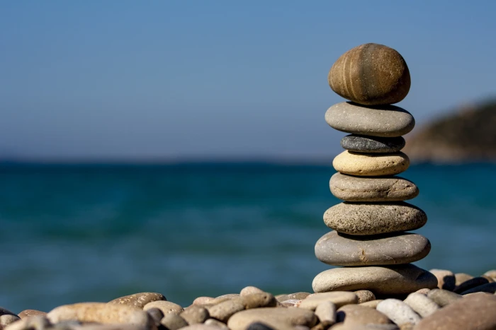 stack of stones near body water sassi sea macro colors 2k 4k