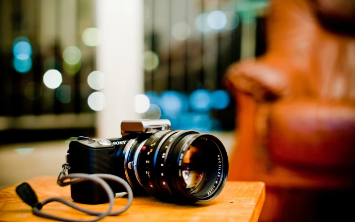 black Sony DLSR camera bokeh depth of field focus on foreground 2k