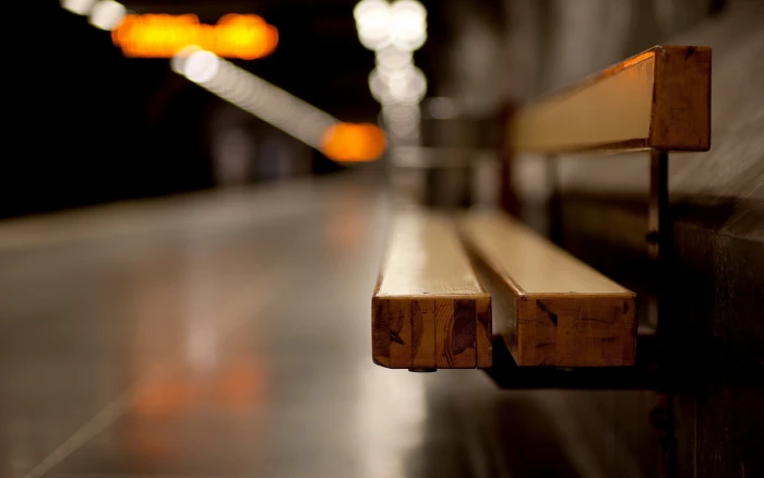 brown wooden bench selective focus photo of with white and orange bokeh 2k