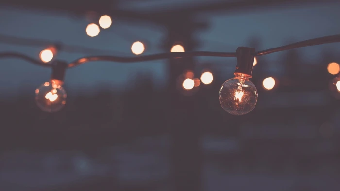 clear bulb string lights shallow focus photography of during night time 2k
