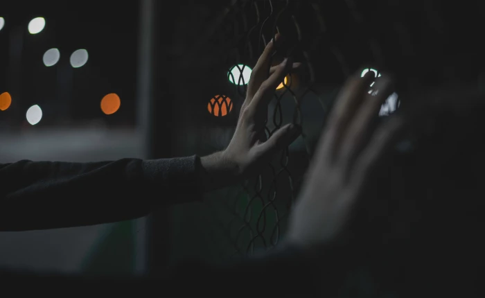 closeup photo of person s hand holding fence hands bokeh lights 2k 4k 5k
