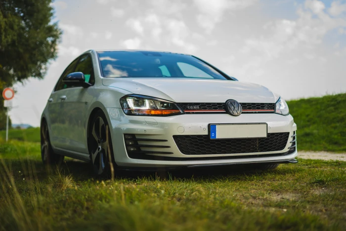 white Volkswagen sedan on green grass vw car european 2k 4k 5k