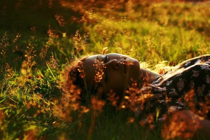 women s black and pink floral top woman wearing white cap sleeved lying on flower field 2k