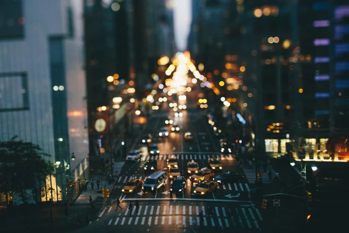 yellow sedan vehicles on road during night time city bokeh