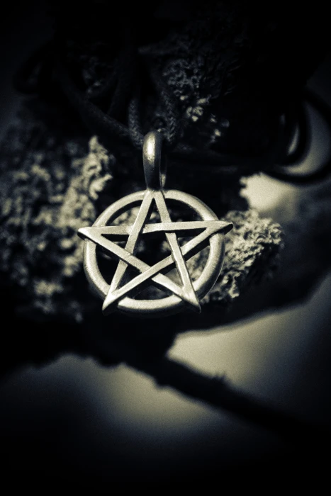 grayscale depth of field photography star pendant silver 2k