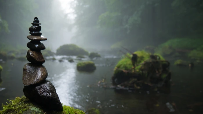 pile of brown stones cairn fog mystical background river 2k 4k 5k