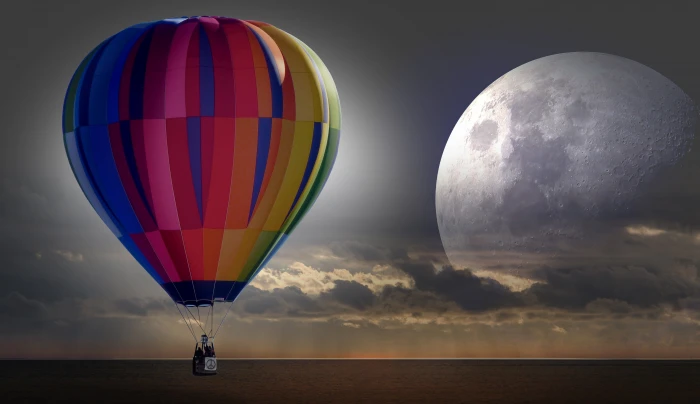 red blue and yellow hot air balloon flying under grey cloudy sky 2k 4k 5k