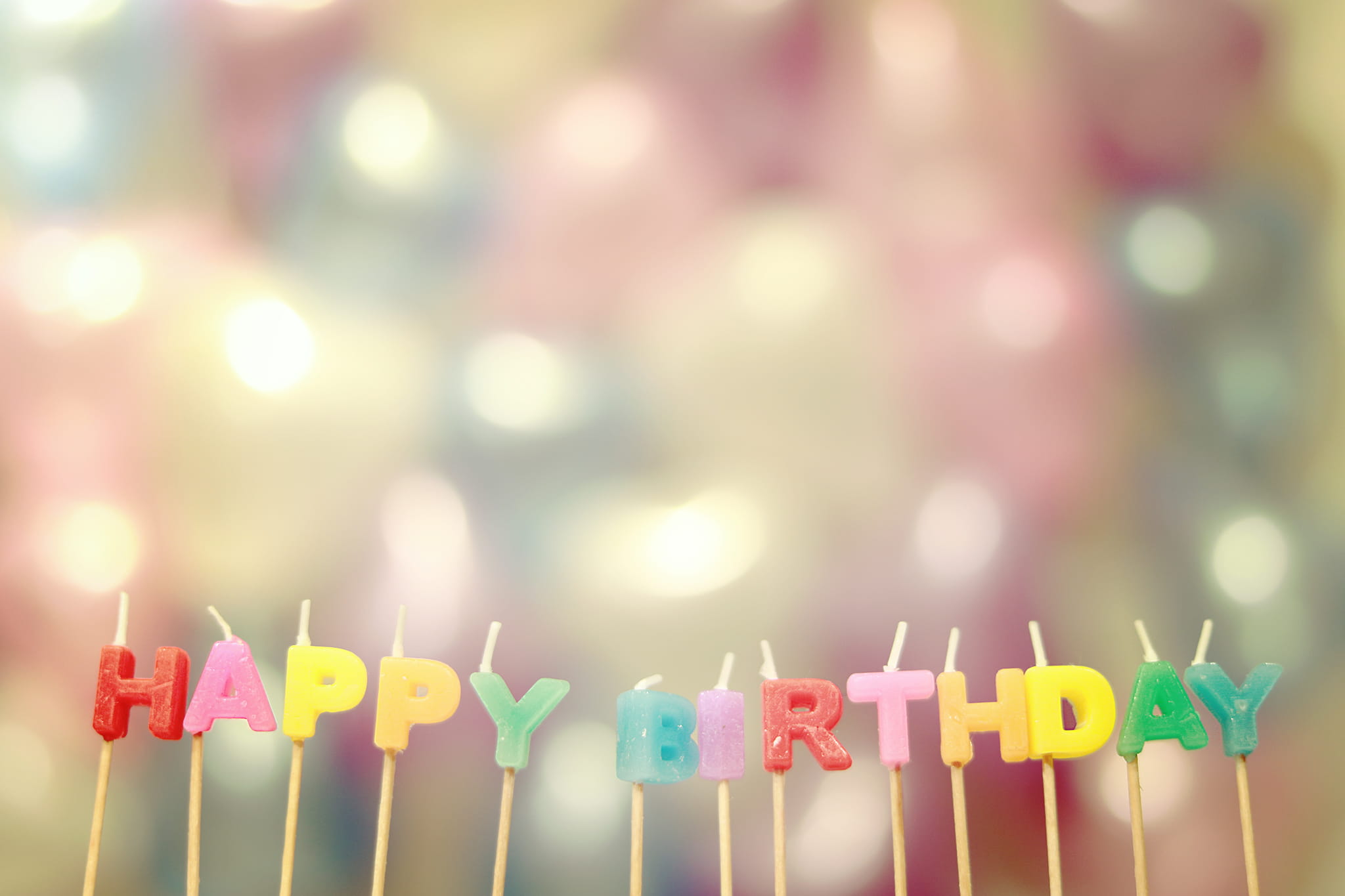 view of Happy Birthday candles celebration decoration defocused 2k