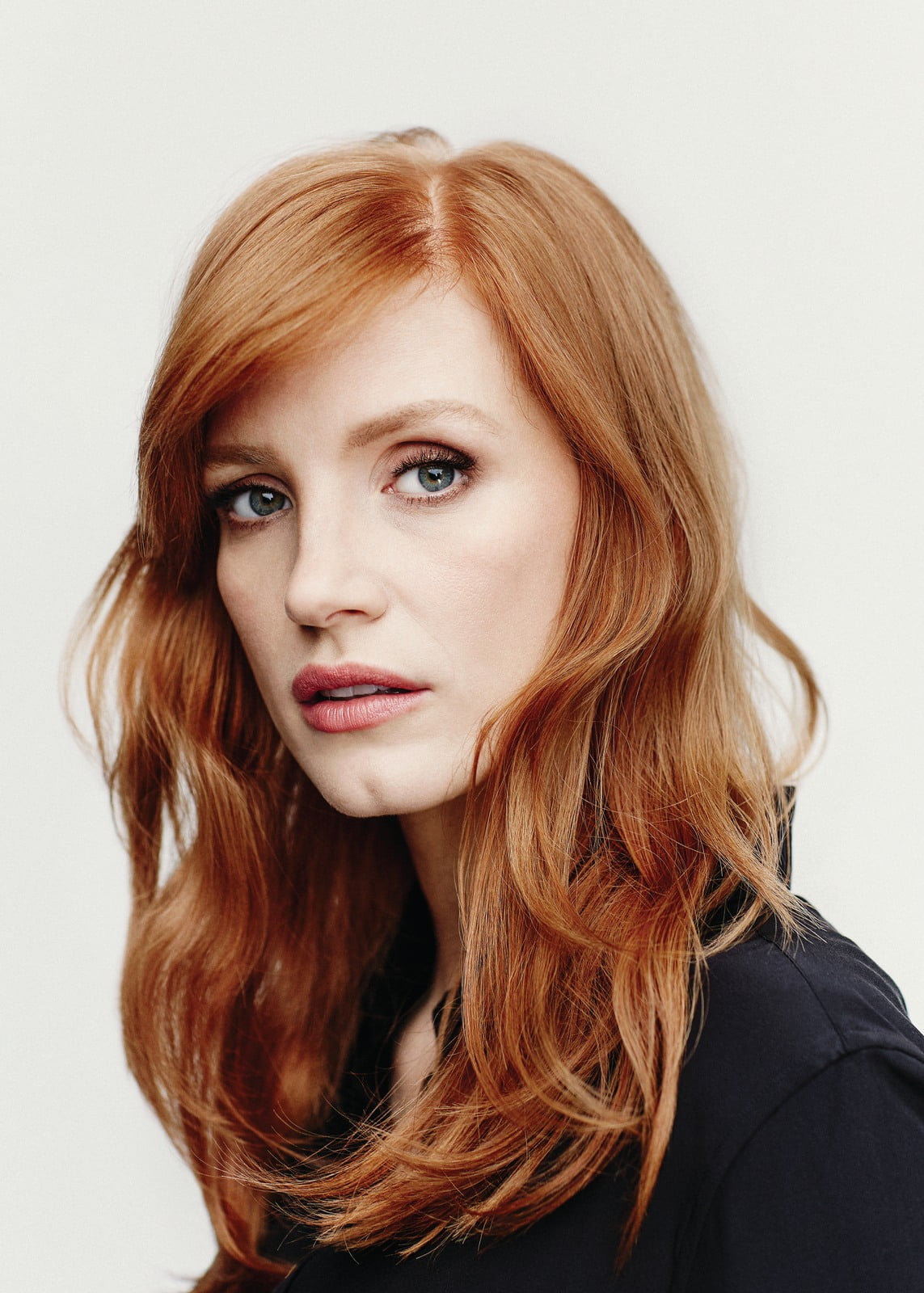 redhead actress Jessica Chastain closeup simple background