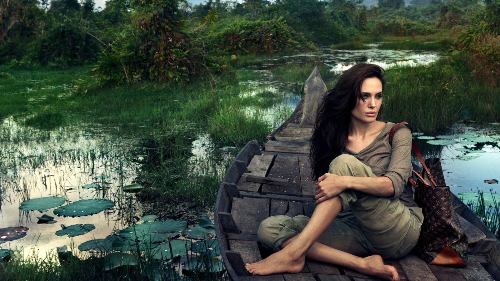 woman sitting on boat painting women model celebrity Angelina Jolie