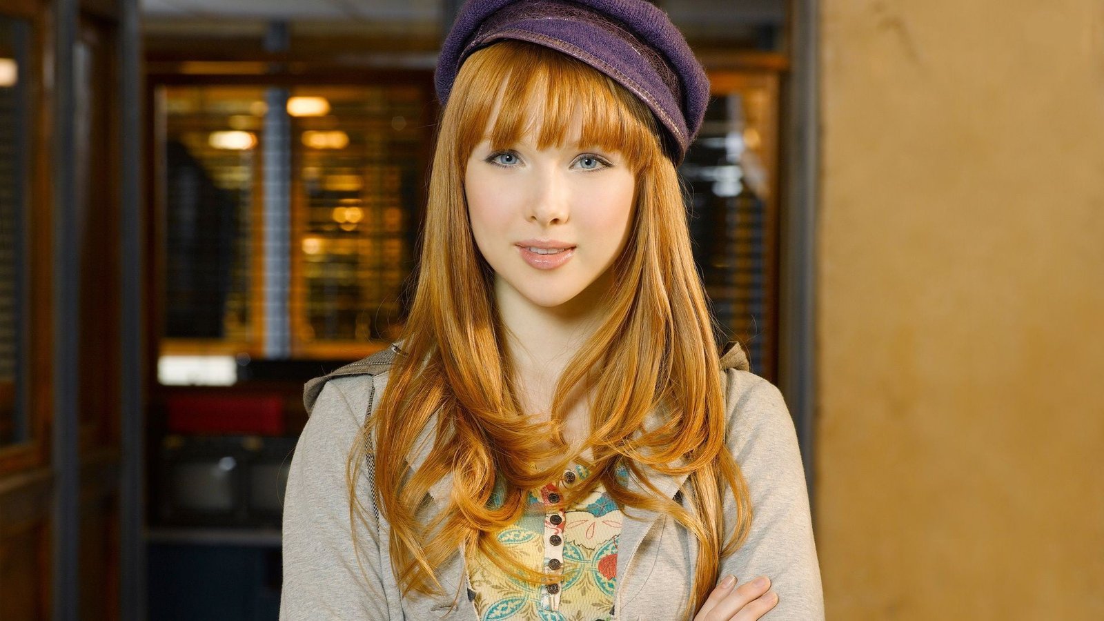 women's purple cap and grey cardiga model redhead face blue eyes