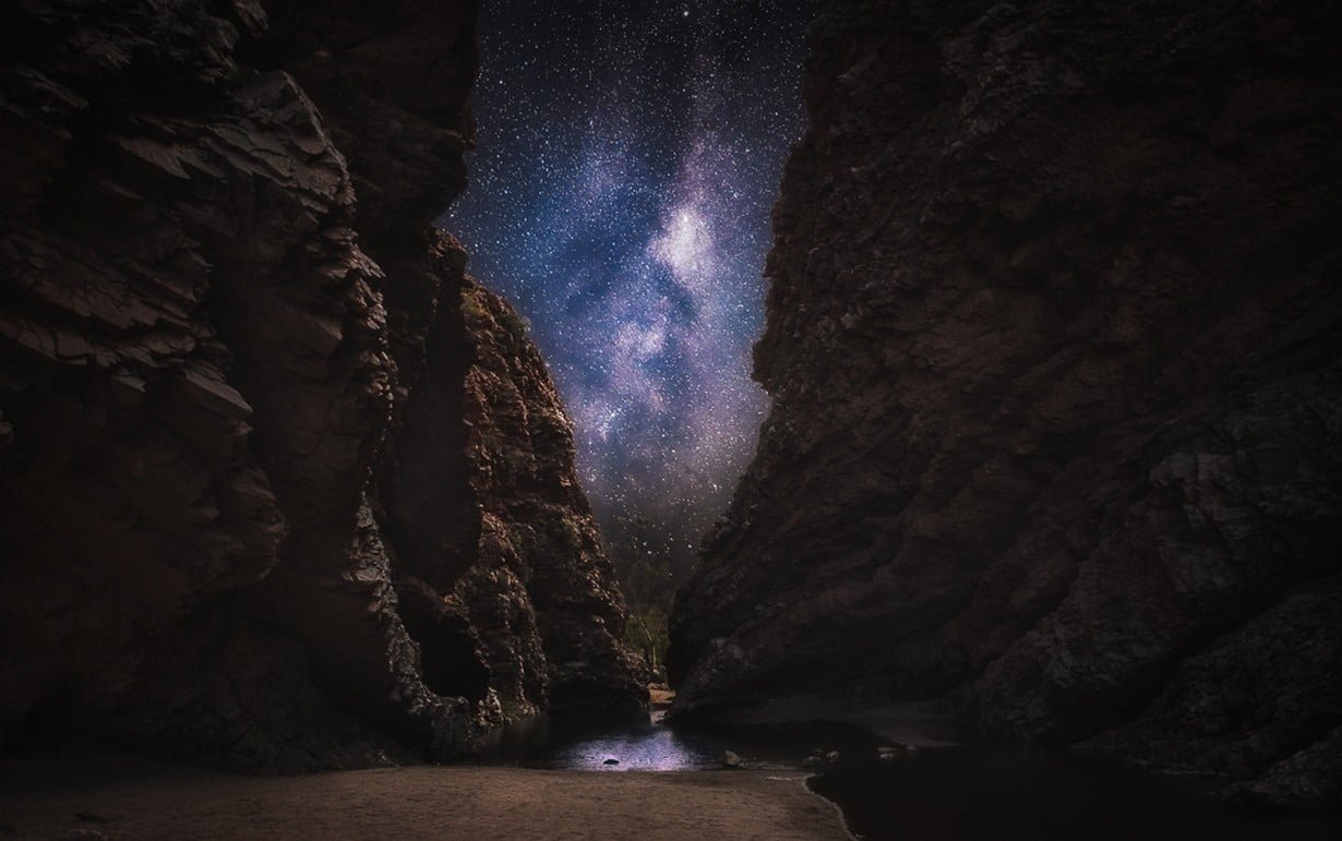 calm body of water in between rock formation nature landscape