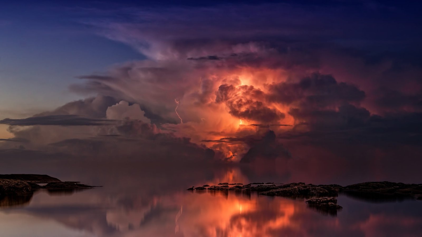lightning illustration rock formation on body of water sky 2k
