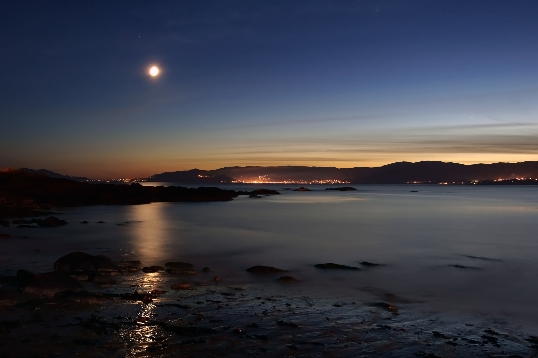 landscape photography of sea and city under blue calm sky portosin 2k