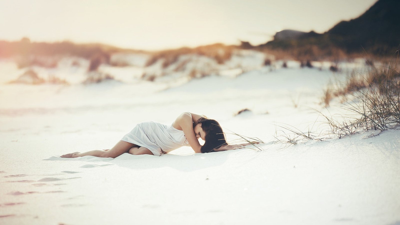 woman in white dress on sandy area under gray sky women beach 2k