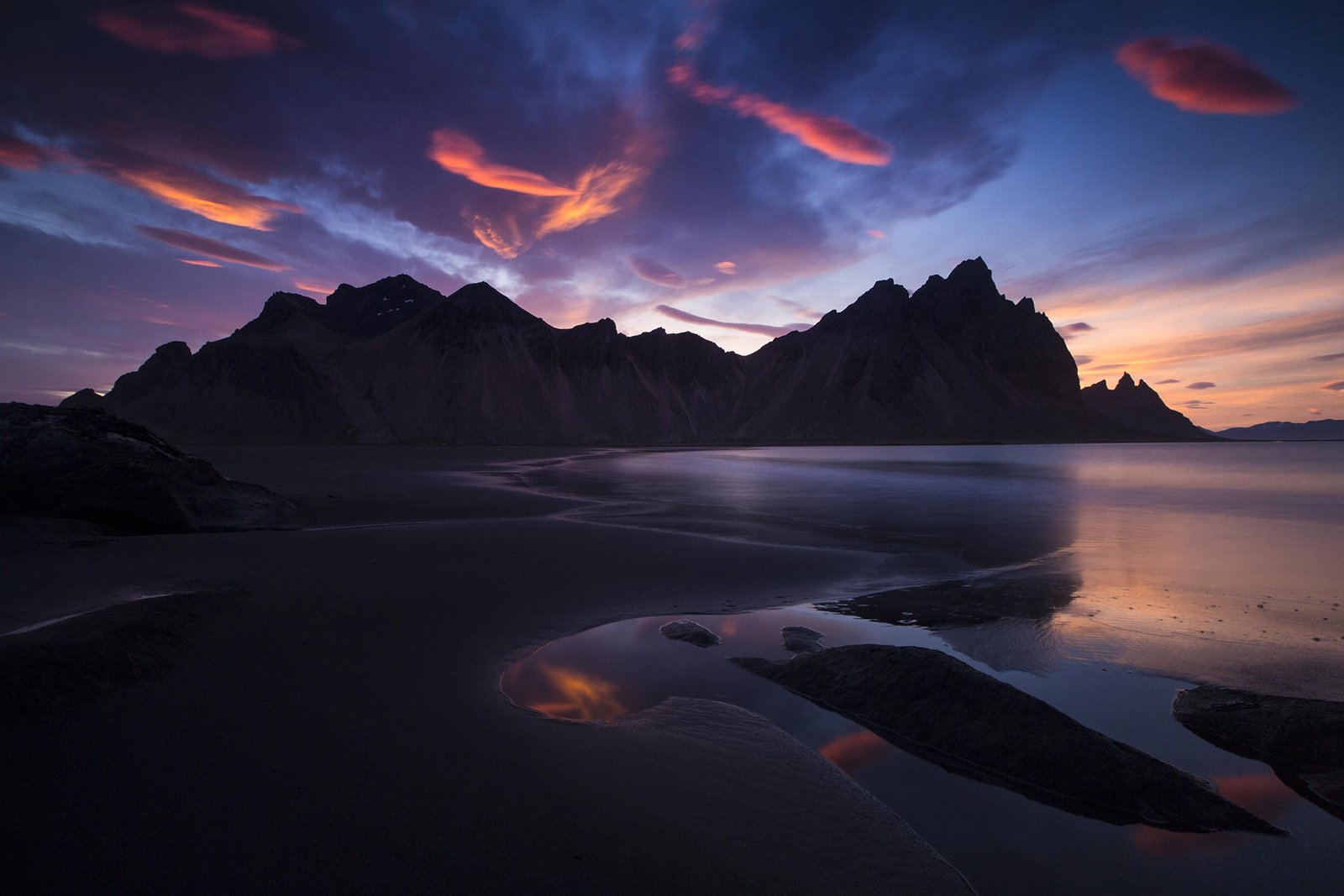 seashore and black rock formations Iceland mountains landscape 2k