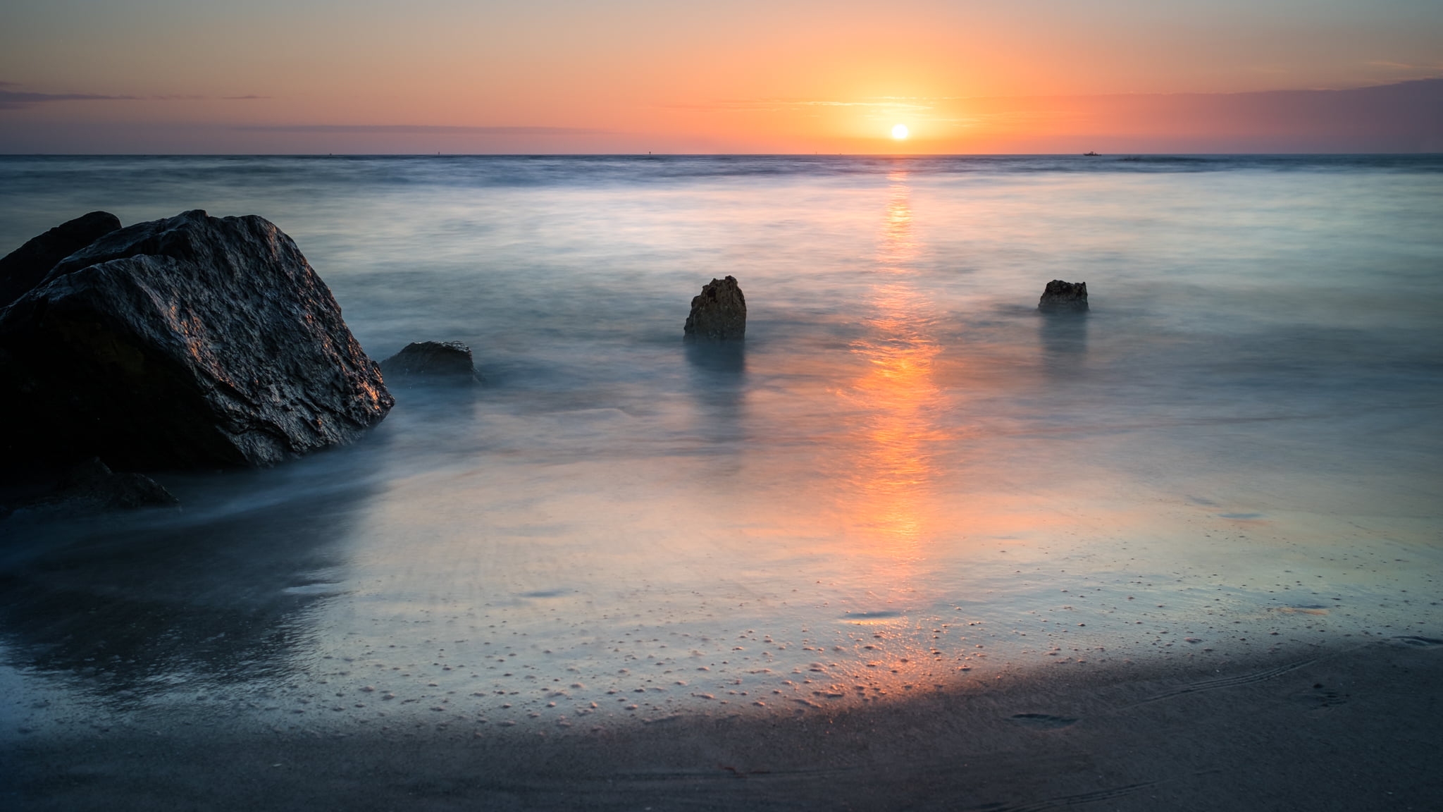 landscape photography of ocean with stone formations during golden hour madeira beach florida 2k