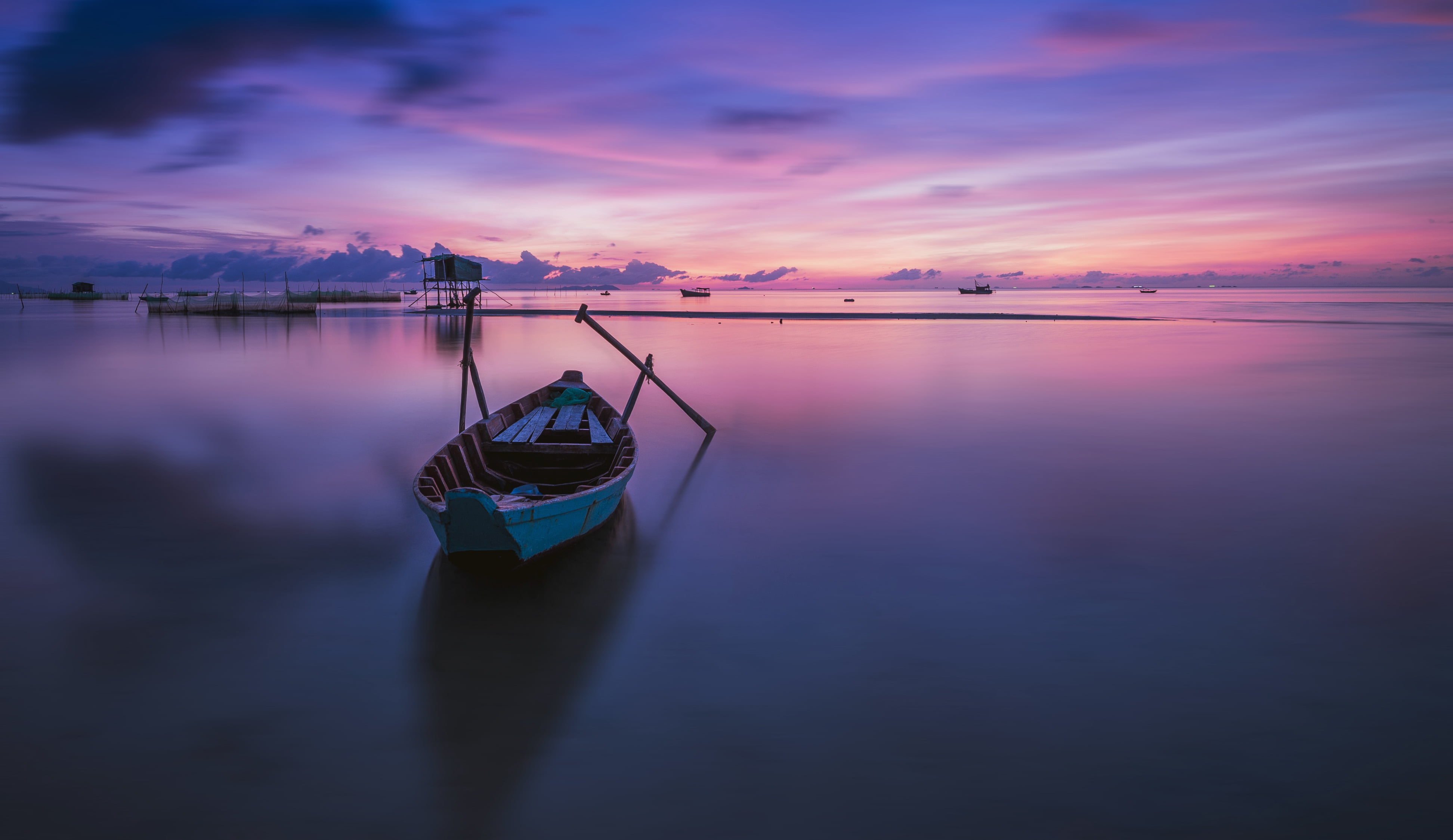 photography of gray canoe on body water under purple sky during daytime vietnam 2k 4k