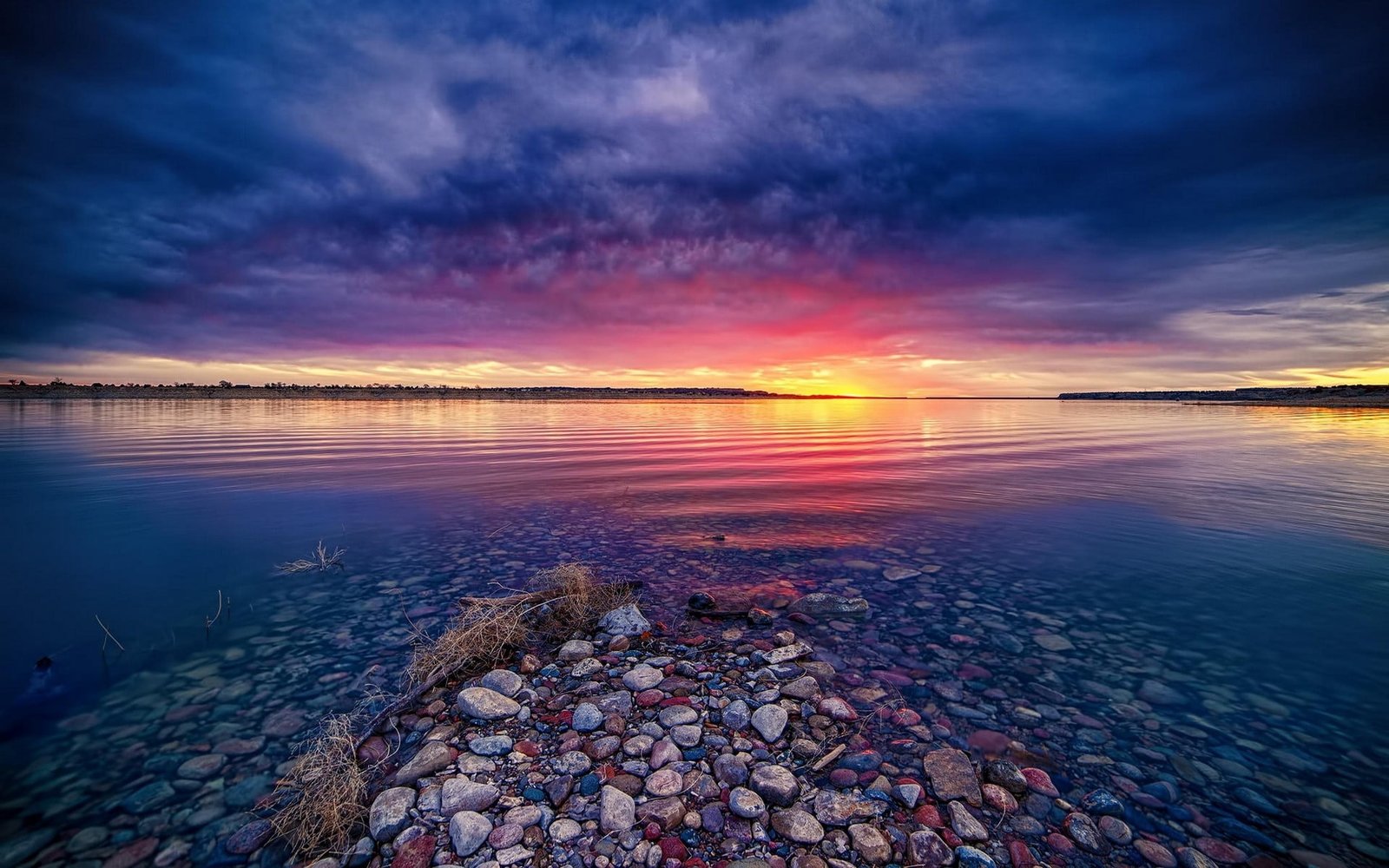 calm body of water at sunset nature landscape lake clouds 2k