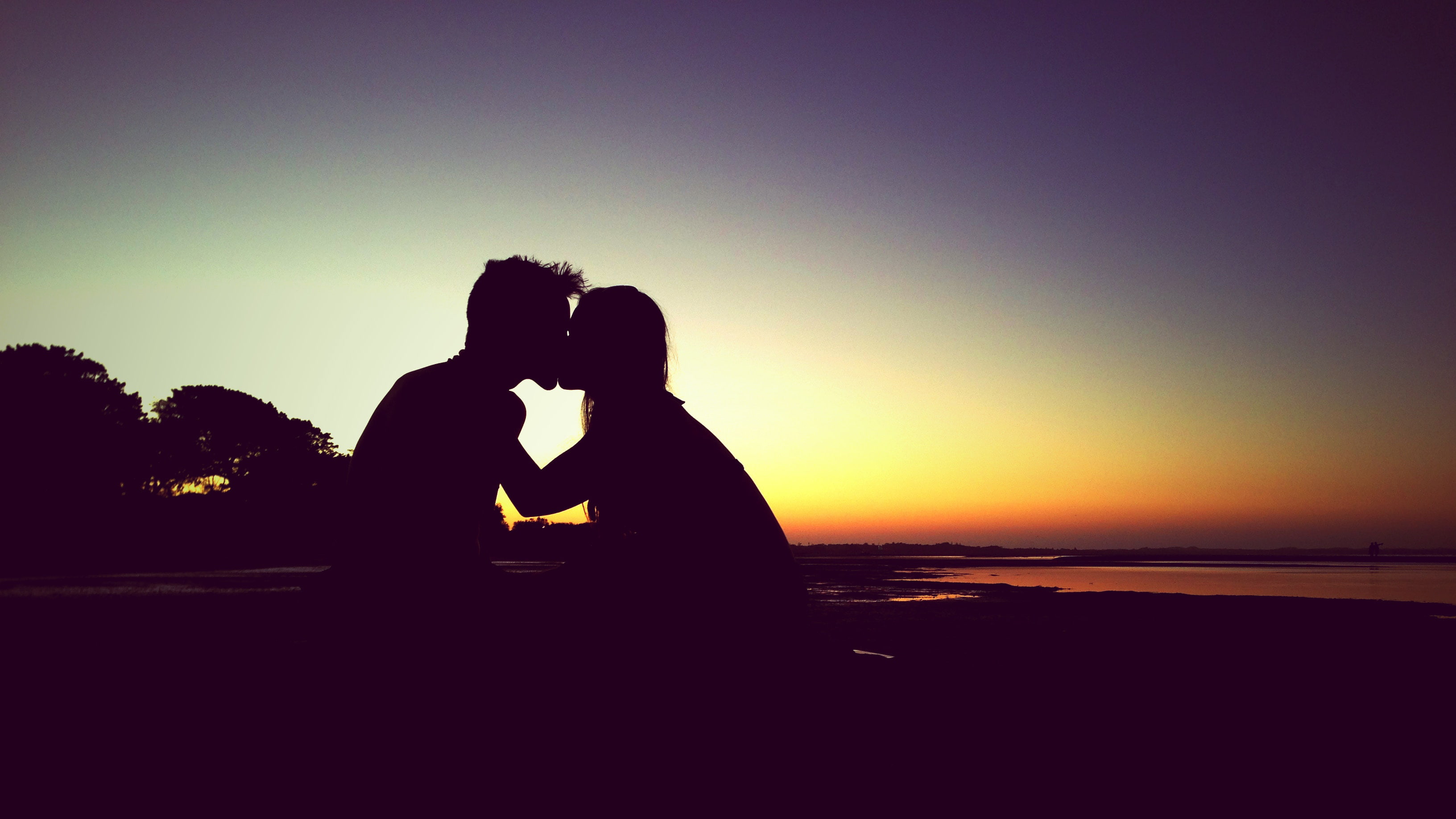 Romantic Couple Kiss Sunset two people sky silhouette 2k