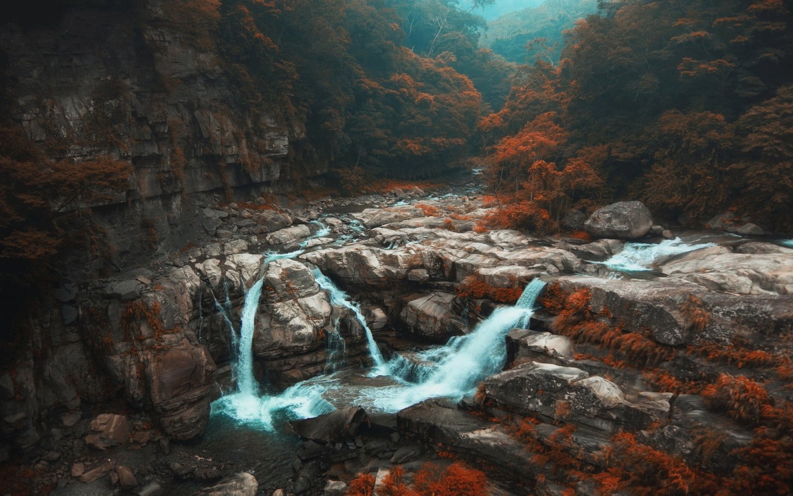 waterfalls surrounded by rocks landscape photo of 2k