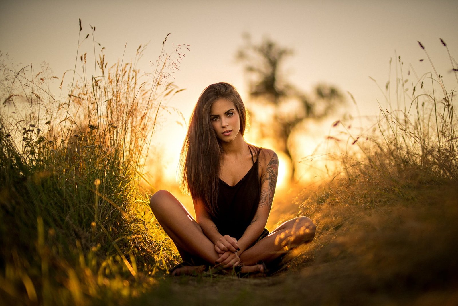 women's black tank top portrait sitting tattoo women outdoors 2k
