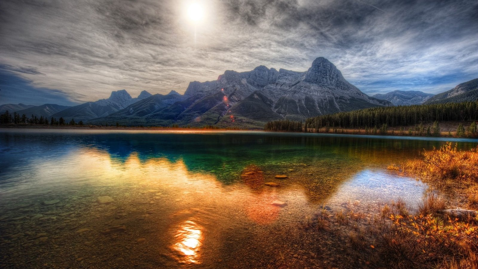 gray mountains calm body of water near mountain at daytime nature 2k