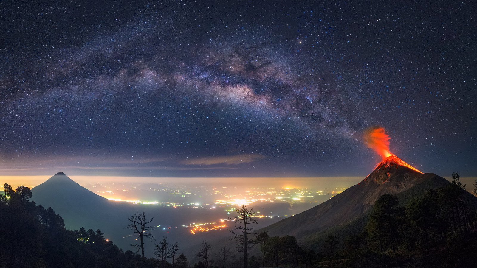 aerial photography of erupting volcano volcanic eruption under starry sky 2k