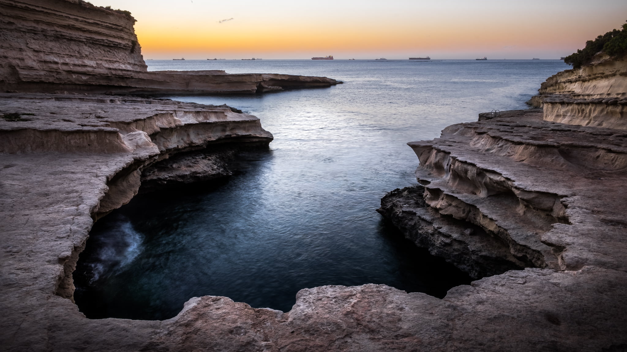 brown rock formation near body of water malta St Peter's pool 2k