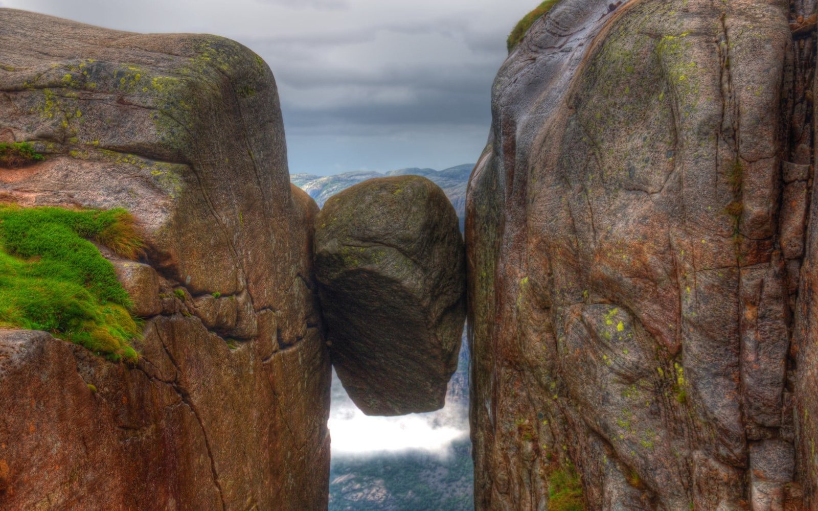 brown rock on mountain stones cliff mountains Norway clouds 2k