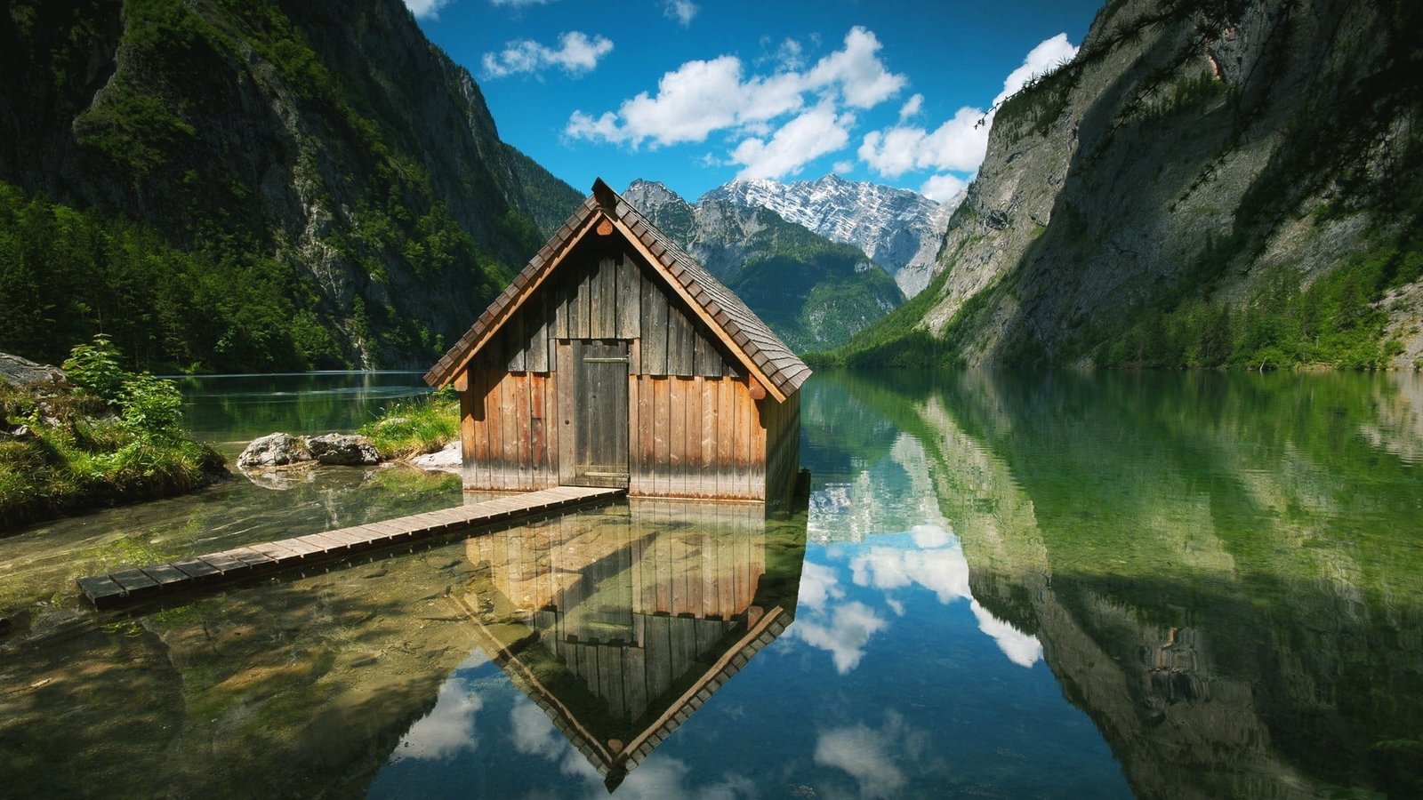 brown wooden house on body of water near mountain lake cabin 2k