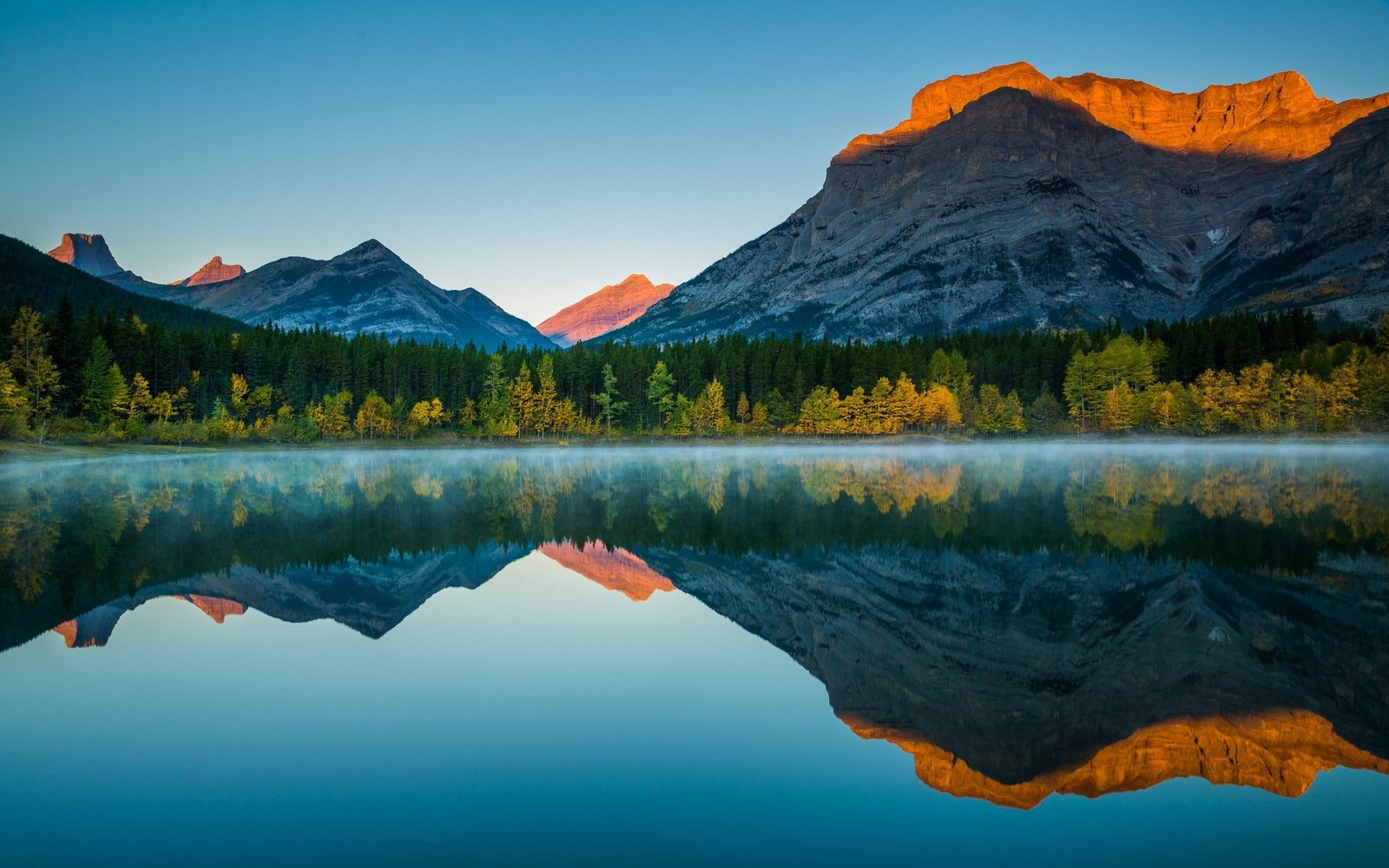mountains and body of water reflective photography hills under calm sky 2k