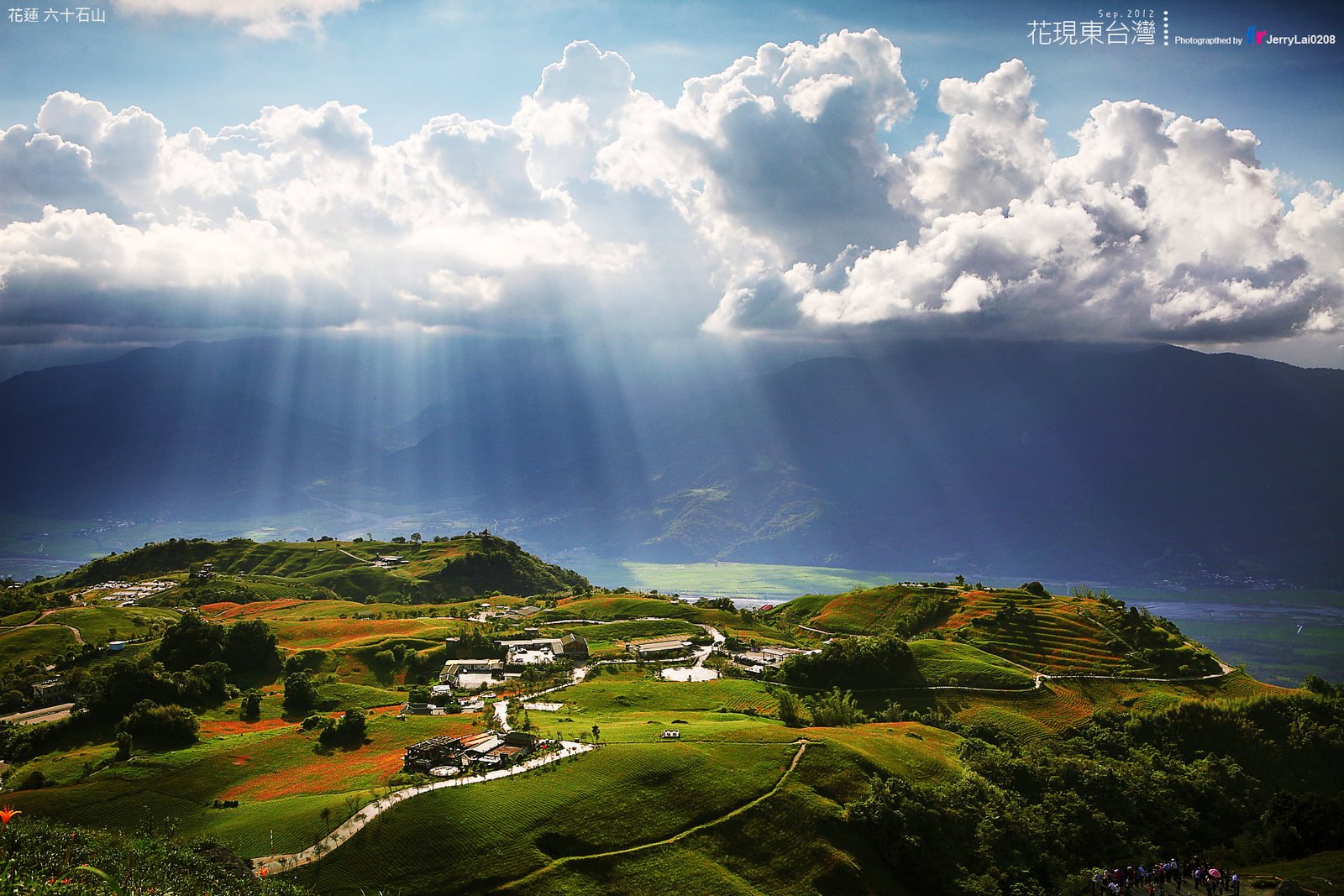 areal photography of town with cumulus nimbus clouds and god rays taiwan 2k
