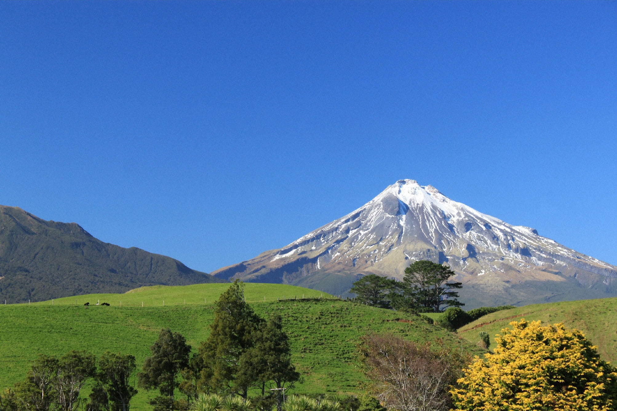 photography of mountain near on field mount taranaki scenic 2k