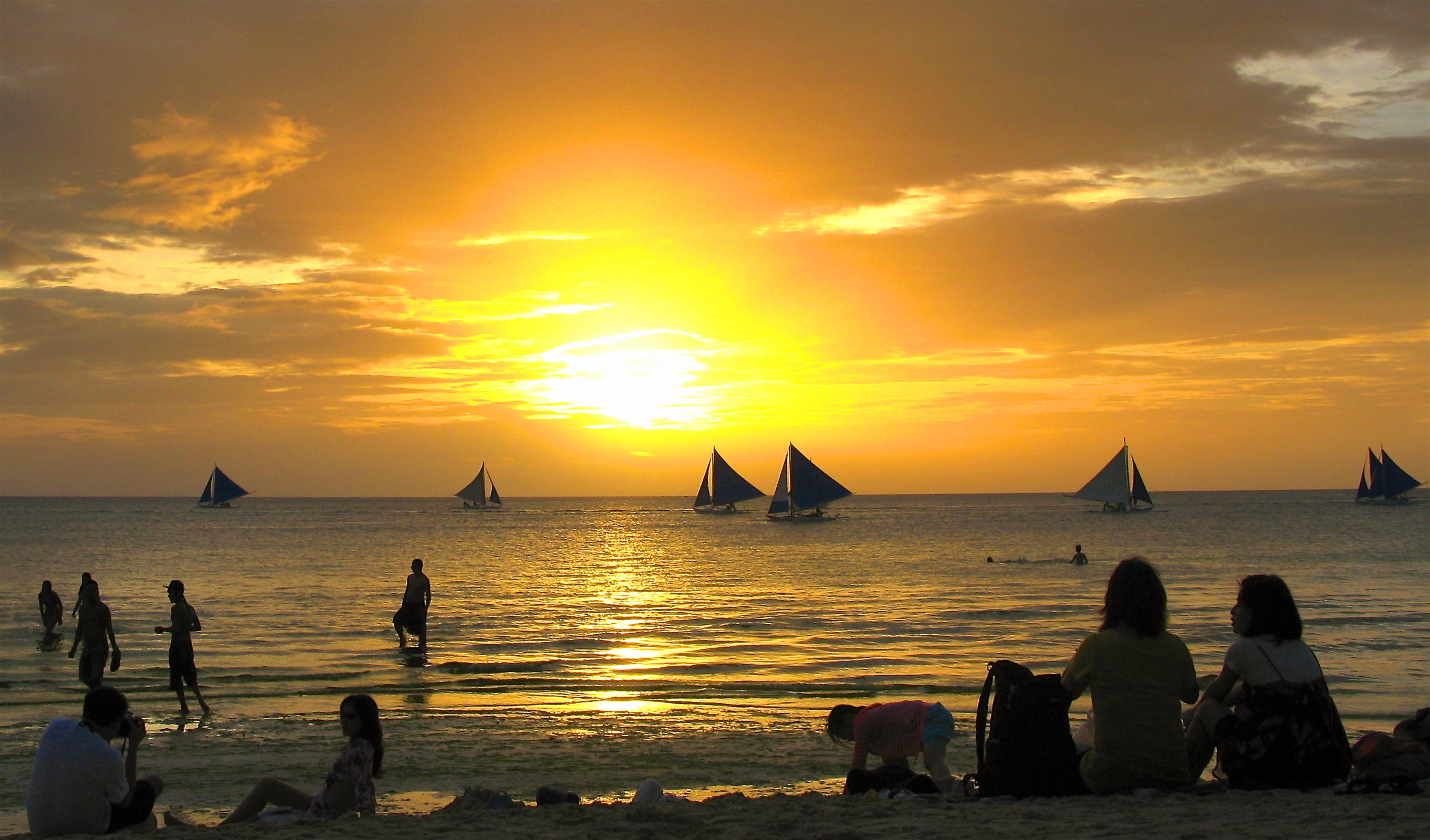 people sitting on seashore during golden hour boracay 2k