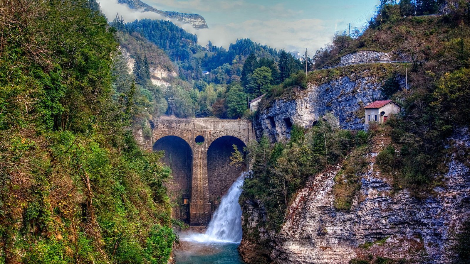 bridge with falls surrounded by trees architecture nature landscape 2k