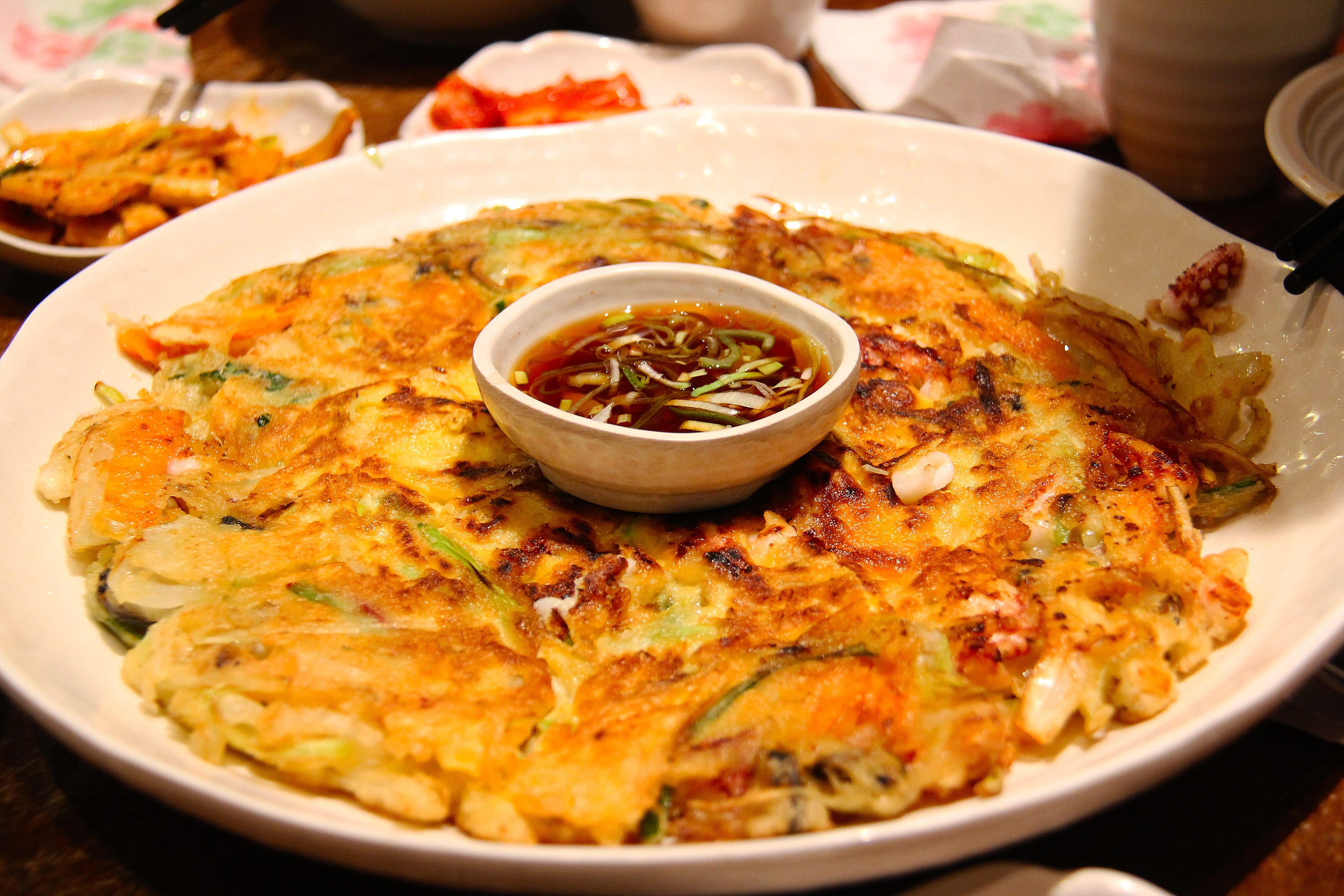 fried food with sauce on plate delicious korean kimchi pancake 2k