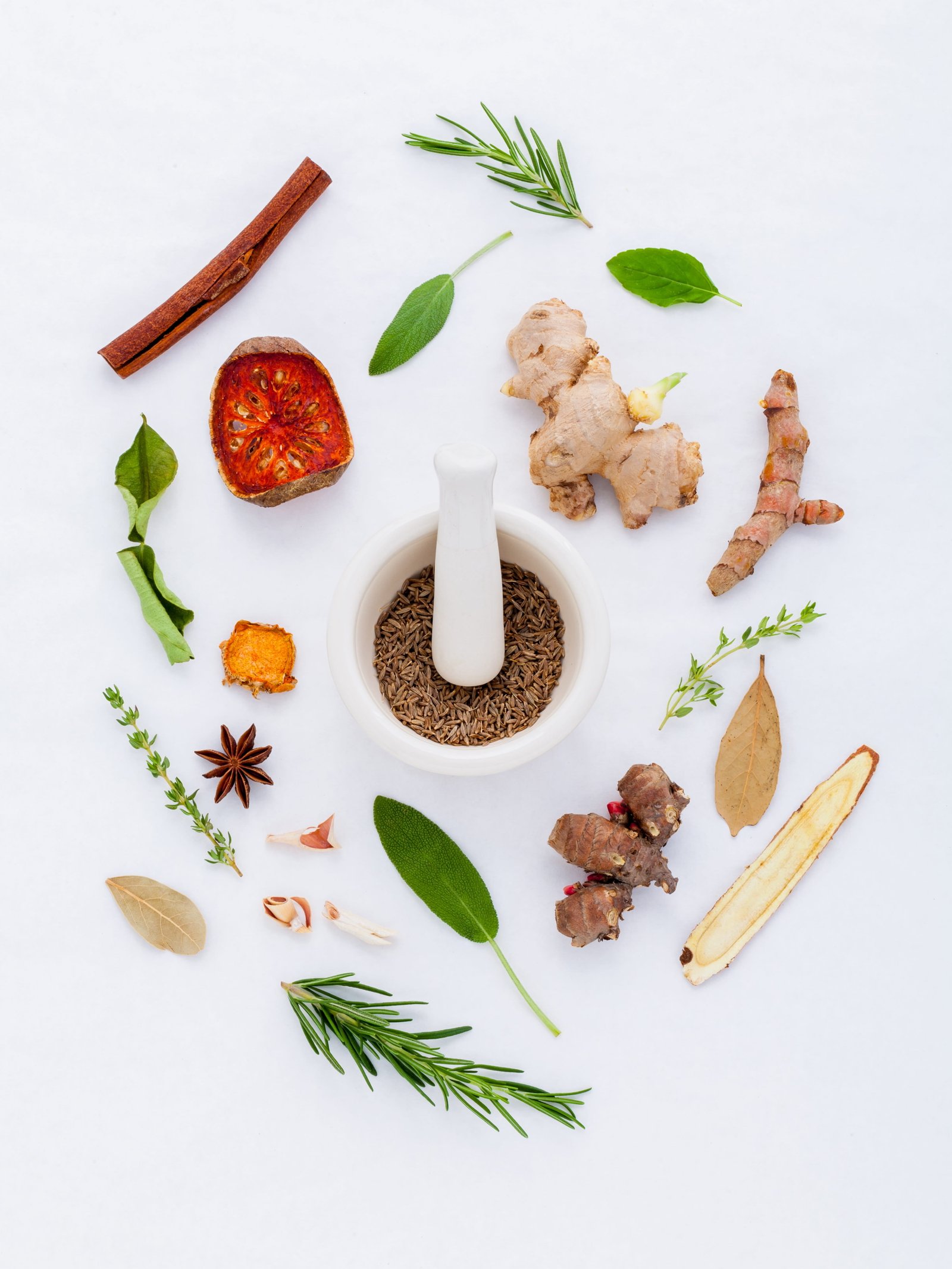 white ceramic mortar and pestle between variety of spices doctor 2k 4k