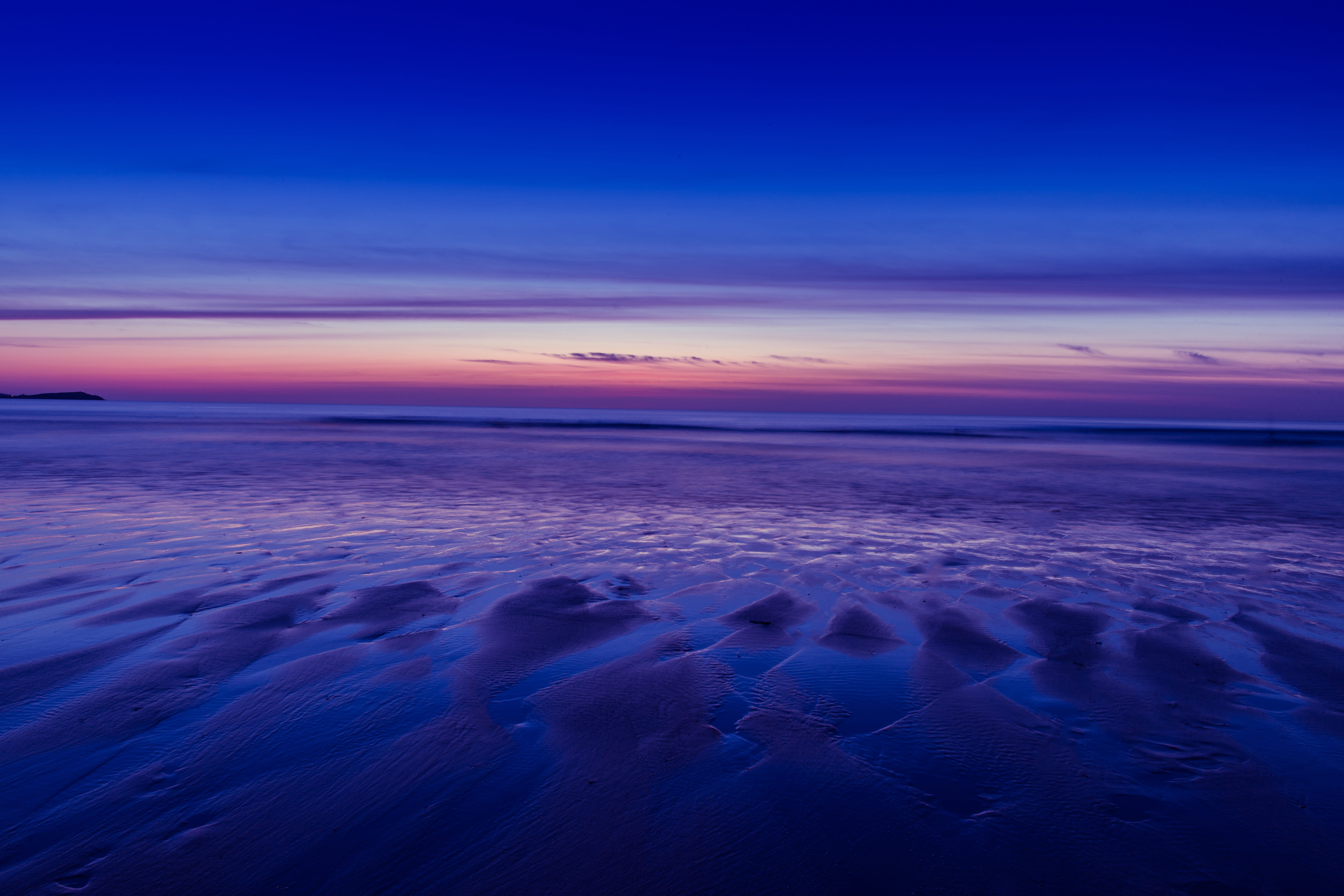 Beach at low tide during a sunset Watergate Bay in Cornwall England 2k 4k 5k