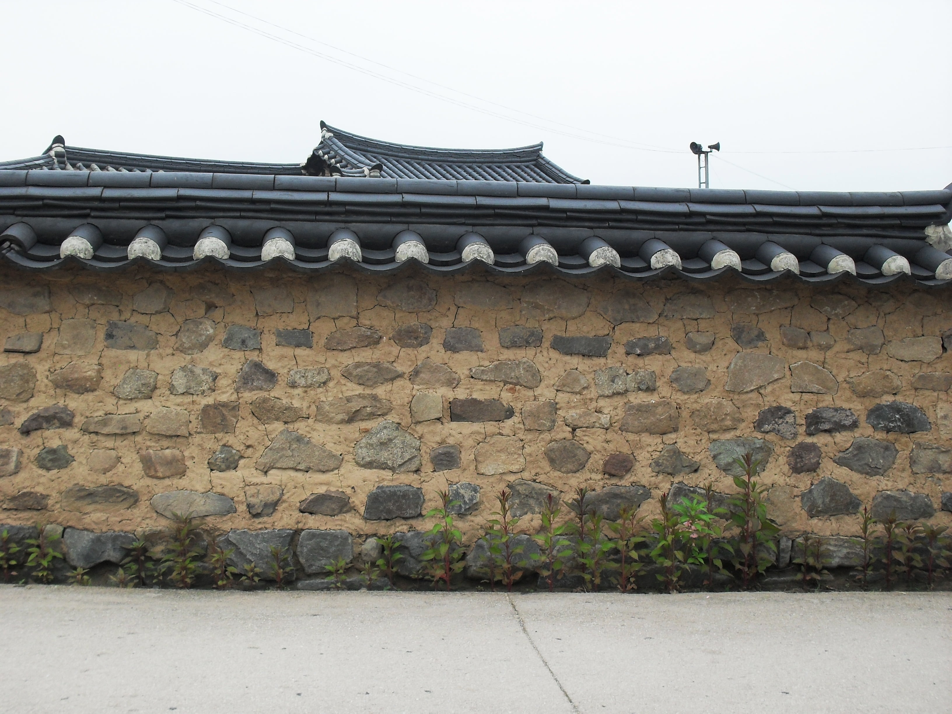 brown and black concrete house at daytime hanok republic of korea 2k