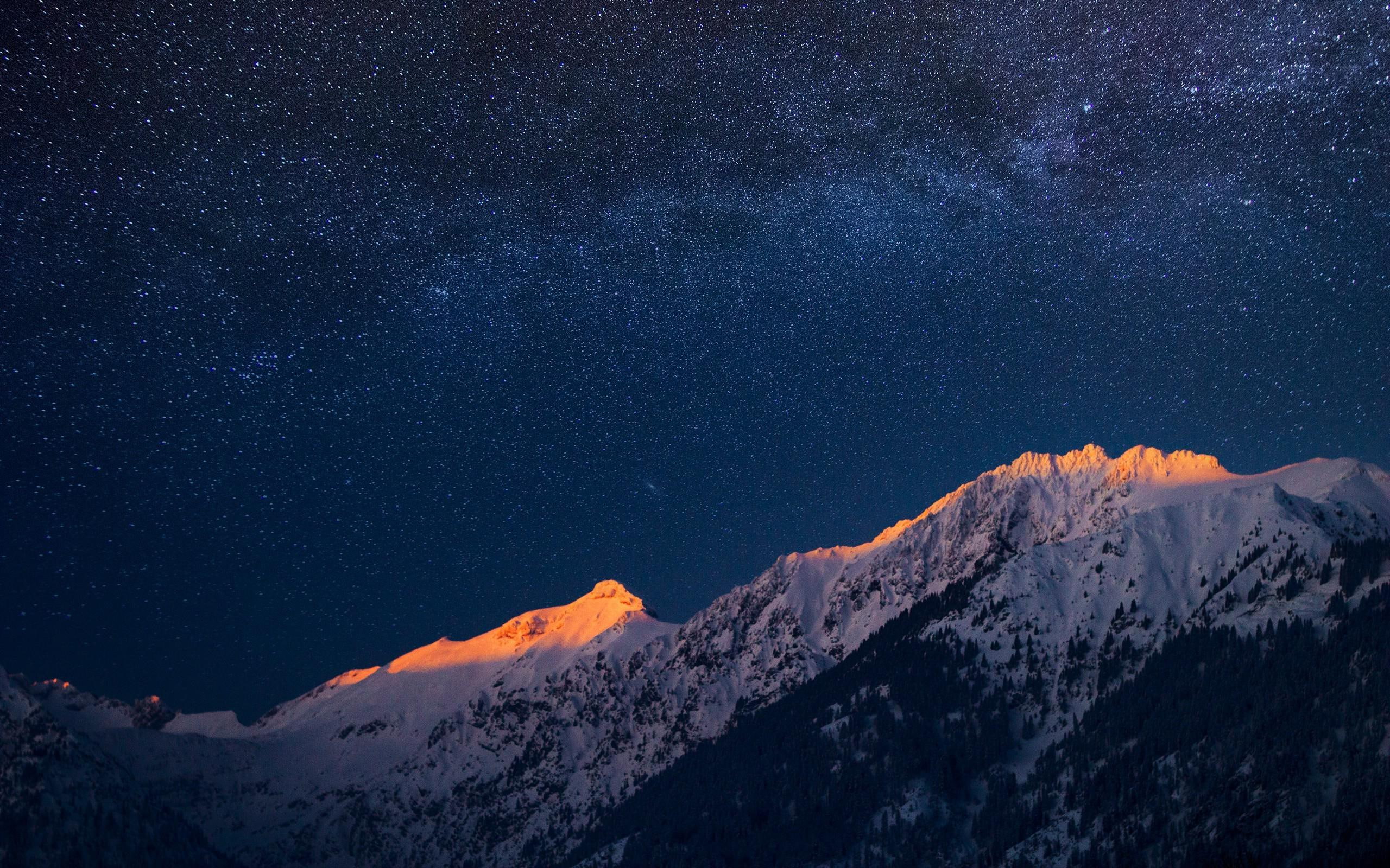 Milky Way galaxy visible in the night sky snow covered mountain 2k